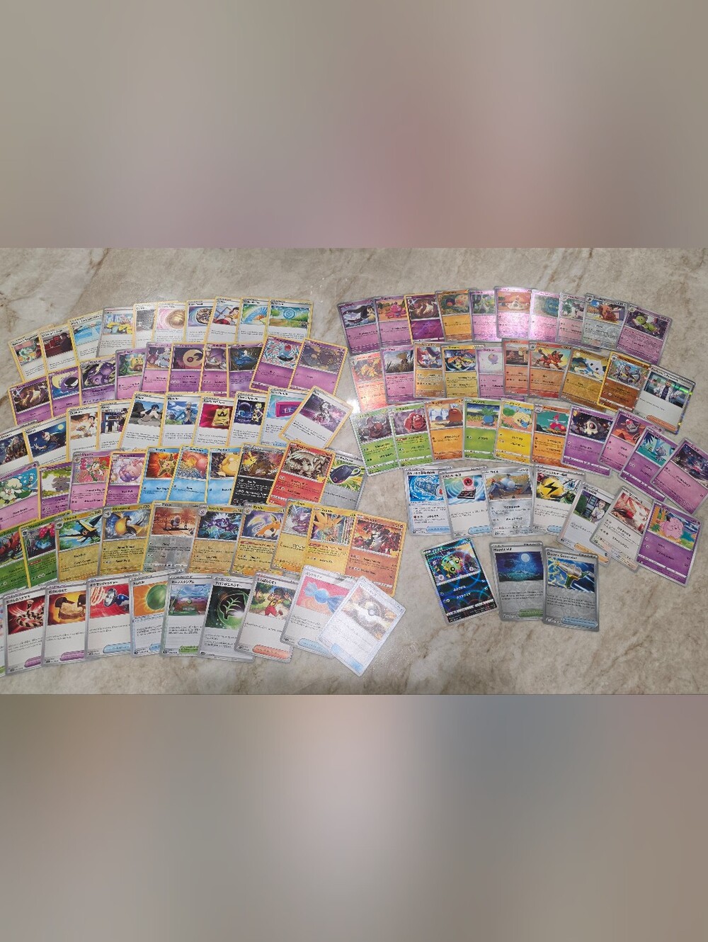 100 Pokémon cards, including Holos, Rares, and Japanese edition
